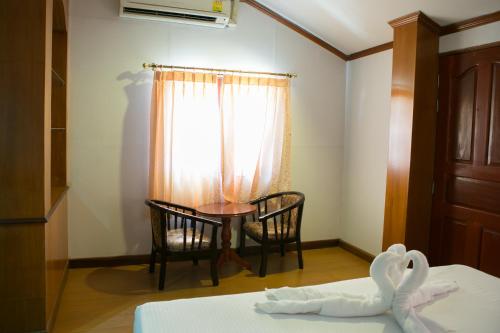 a room with a table and chairs and a window at Haadrin Resort in Haad Rin