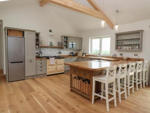 a kitchen with a wooden counter top and a kitchen island at Cotswold View in Chipping Norton