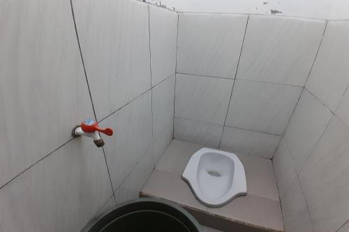 a bathroom with a toilet in a stall at SPOT ON 92814 Gioba Kost Syariah in Grobogan