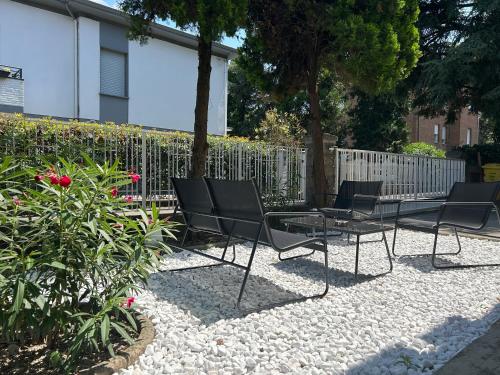 a group of chairs sitting in front of a fence at SM Hospitality LAGHI in Reggio Emilia