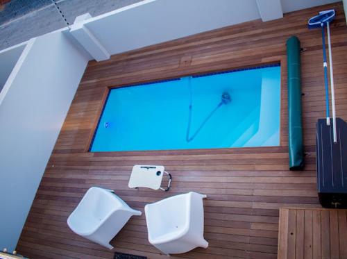 a bathroom with two toilets and a large window at Sapphire Seas Beach Apartment in Humewood