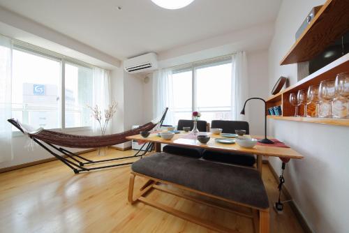 a dining room with a table and a hammock at AMS TOWER 2101 in Sapporo