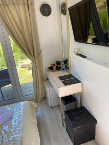 a small bathroom with a sink and a mirror at MMA apartament in Klaipėda