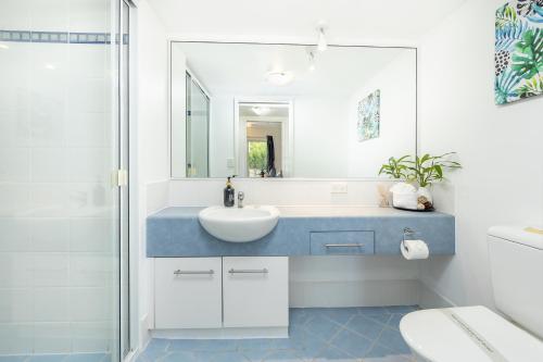 a bathroom with a sink and a mirror at Cairns Esplanade 2BR Waterfront Apartment Sleeps 6 in Cairns