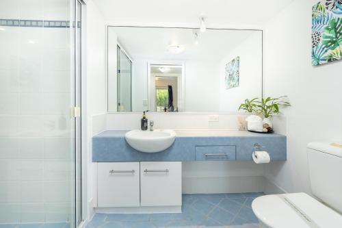 a bathroom with a sink and a mirror at Cairns Esplanade 2BR Waterfront Apartment Sleeps 6 in Cairns
