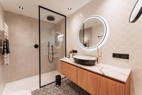 a bathroom with a sink and a mirror at Strandhotel Kurhaus Juist in Juist