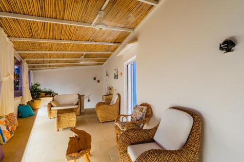 a living room with wicker chairs and a cat sitting in the room at Le Antiche Dimore di Cadia in Ugento