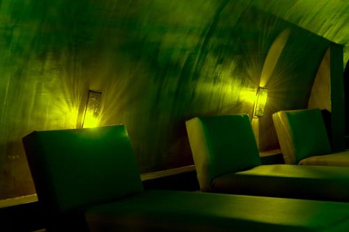 a room with two chairs and a table and a lamp at Life Gallery Hotel & Spa in Korçë