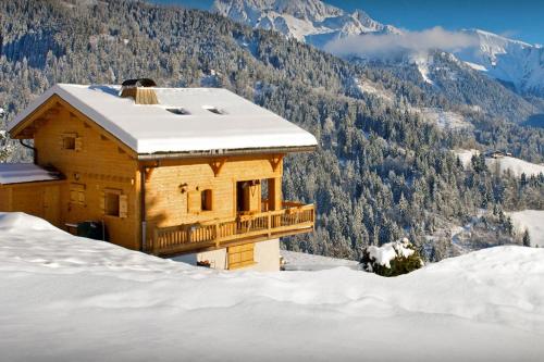 a house on top of a snow covered mountain at Chalet Chenavray - OVO Network in Manigod