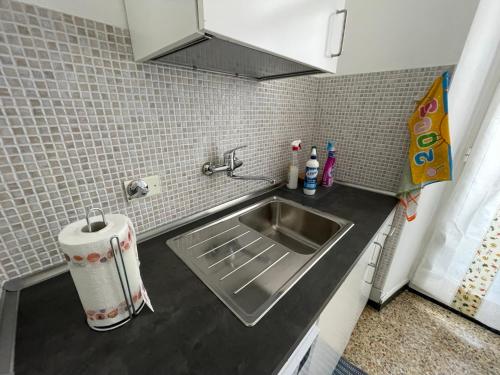 a kitchen with a sink and a counter top at La Finestra su Savona, Appartamento Centrale in Savona