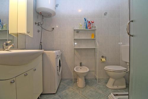 a bathroom with a sink and a toilet and a sink at Apartment Stinjan 2287 in Pula