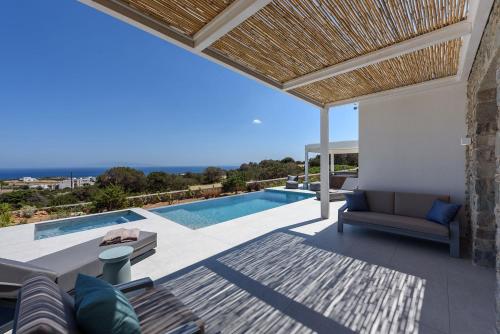 a villa with a view of a swimming pool at Villa Solevara - luxury villa with Infinity Pool, jacuzzi, cinema room & luxury amenities in Aspro Chorio Paros