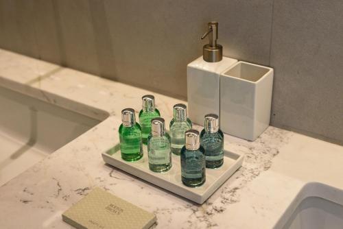 a bunch of bottles sitting on a shelf in a bathroom at Villa Solevara - luxury villa with Infinity Pool, jacuzzi, cinema room & luxury amenities in Aspro Chorio Paros