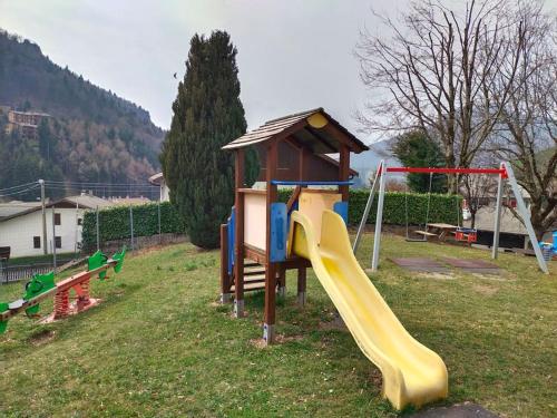 a playground with a slide and a play structure at Appartamento con la vista in Oltre il Colle