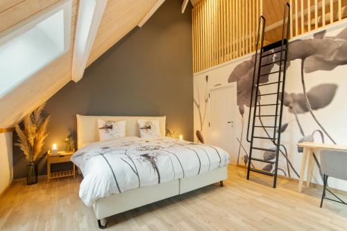 a loft bedroom with a bed and a ladder at Hoeve-C in Ieper