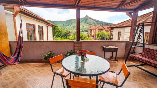 a table and chairs on a balcony with a view at Levanto in Mtskheta