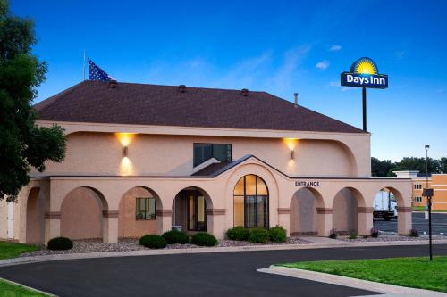a building with a sign that reads durham at Days Inn by Wyndham Austin in Austin