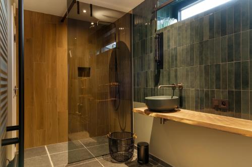 a bathroom with a sink and a shower at Hoeve-C in Ieper