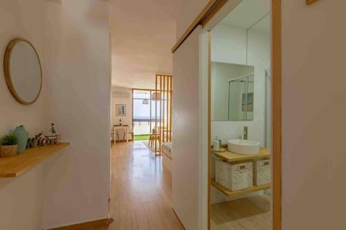 a bathroom with a sink and a mirror at Dunas House Playa del Inglés in San Bartolomé