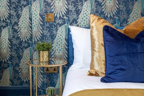a bedroom with a bed and a blue and white wallpaper at Luxury Accommodation In The City Centre With Free Parking in Bournemouth