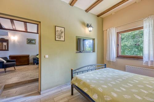 a bedroom with a bed and a living room at Wellness House On The River Kupa - Happy Rentals in Banska Selnica