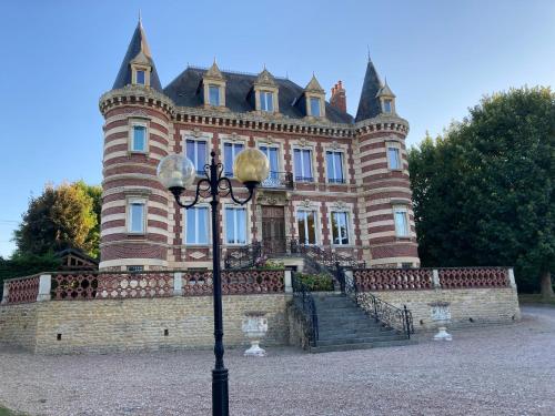 a building with a street light in front of it at Au domaine des roches in Saint-Pierre-sur-Dives