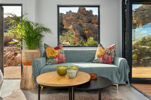 a living room with a couch and a table at Rocklands Eco Retreat - Adults Only in Cederberg