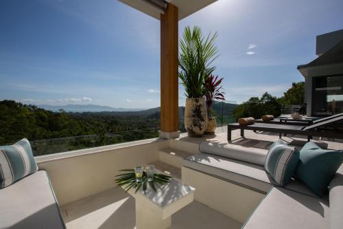 a balcony with a view of the mountains at Zog Villas in Koh Samui 