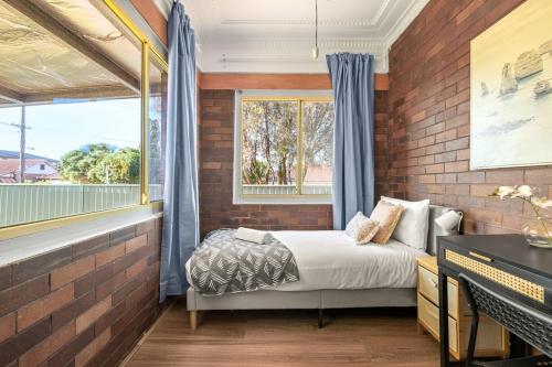 a bedroom with a bed and a brick wall at Comfort Single Room - Private - Prime Spot in Sydney