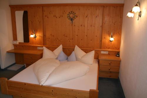 a bedroom with a bed with white pillows at Haus Oberland in Sankt Anton am Arlberg