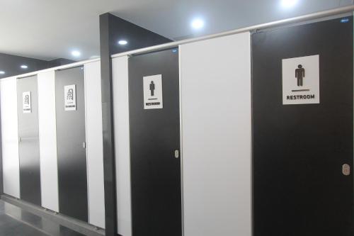 a row of restroom stalls in a building at The Mira Hotel Chiang Rai in Chiang Rai