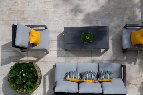 an overhead view of a blue couch with yellow pillows at Zog Villas in Koh Samui 