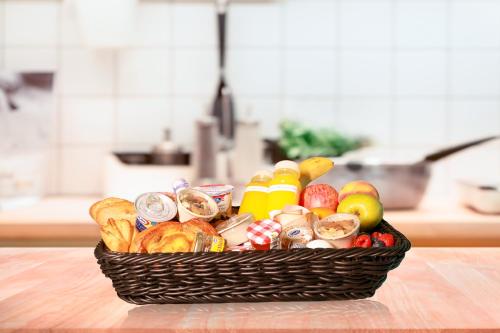 a basket filled with different types of food on a table at Premium 2+1 BR condo in the heart of Bluewaters Island in Dubai