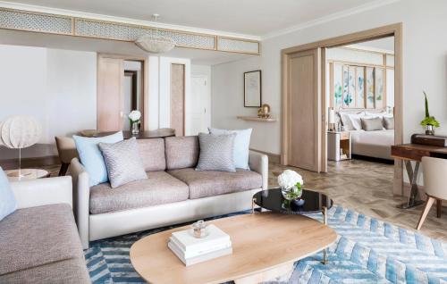 a living room with a couch and a table at One&Only Le Saint Géran, Mauritius in Belle Mare