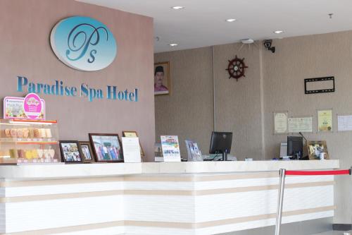 a store counter with a sign on the wall at Paradise Spa Hotel in Port Dickson