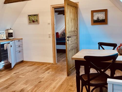 a kitchen and dining room with a table and chairs at KulturGut Ulrichshalben in Ulrichshalben