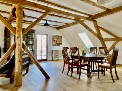 a dining room with a table and chairs at KulturGut Ulrichshalben in Ulrichshalben