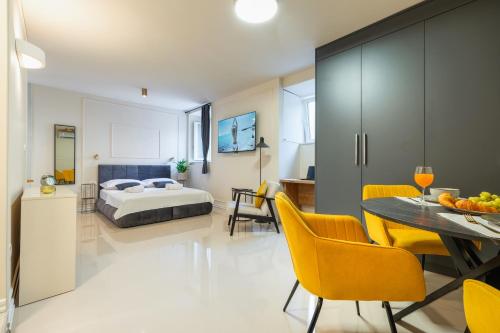 a bedroom with a bed and a table and chairs at Villa Spalato in Split
