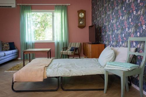 1 dormitorio con 1 cama y 1 silla en Norrby Residence,my vintage bnb 