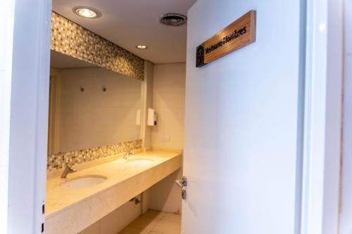 a bathroom with two sinks and a large mirror at O2 Hotel Mar del Plata in Mar del Plata