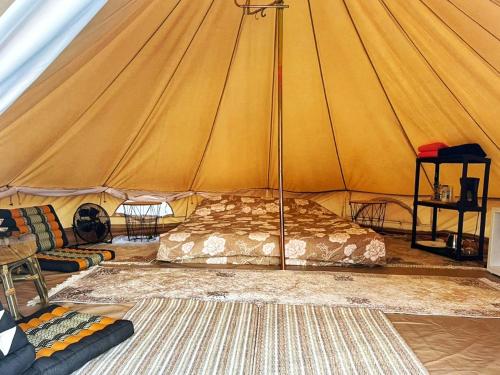 a tent with a bed and a couch in a room at Lakeview Glamping in Staro Myasto