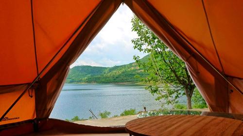 an orange tent with a view of a lake at Lakeview Glamping in Staro Myasto