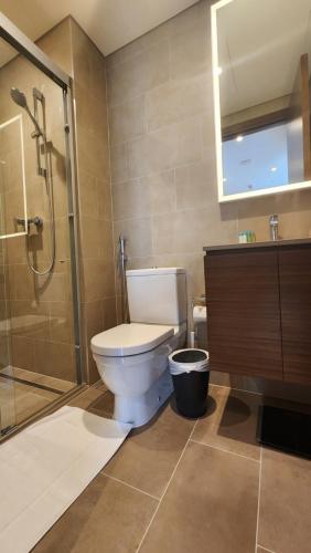 a bathroom with a toilet and a glass shower at STAY BY LATINEM Luxury 1BR Holiday Home CVR A1410 near Burj Khalifa in Dubai