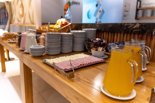 a table with food and a jug of orange juice at O2 Hotel Mar del Plata in Mar del Plata