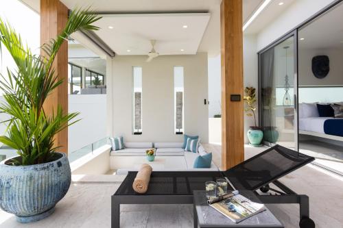 a living room with a couch and a table at Zog Villas in Koh Samui 