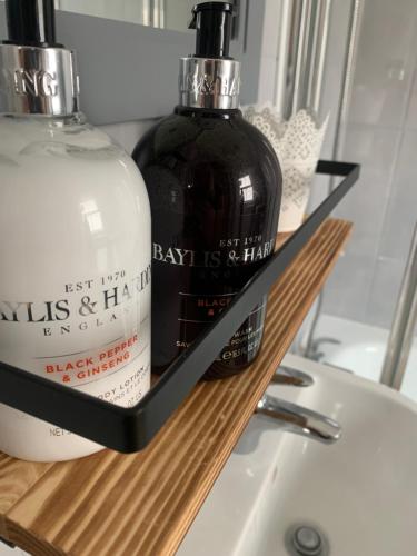 a bottle of soap on a shelf next to a sink at Beautiful Brighton Home in Brighton & Hove