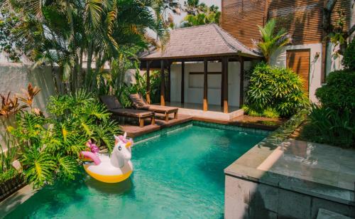 a swimming pool with a rubber duck in the water at Bale Gede Luxury Villas in Seminyak