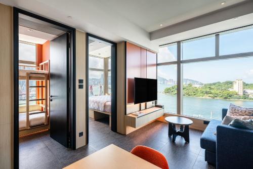 a hotel room with a view of the water at TOWNPLACE WEST KOWLOON in Hong Kong