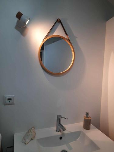 a bathroom with a sink and a mirror on the wall at Grandma villa in Pataias