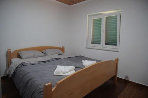 a bedroom with a bed with two towels on it at House for rest in Mostar